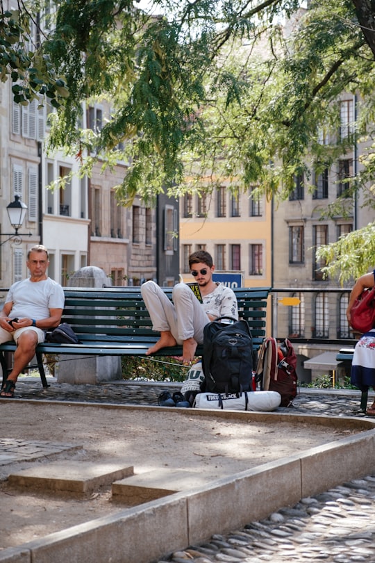 two men sitting on bench in Geneva Switzerland