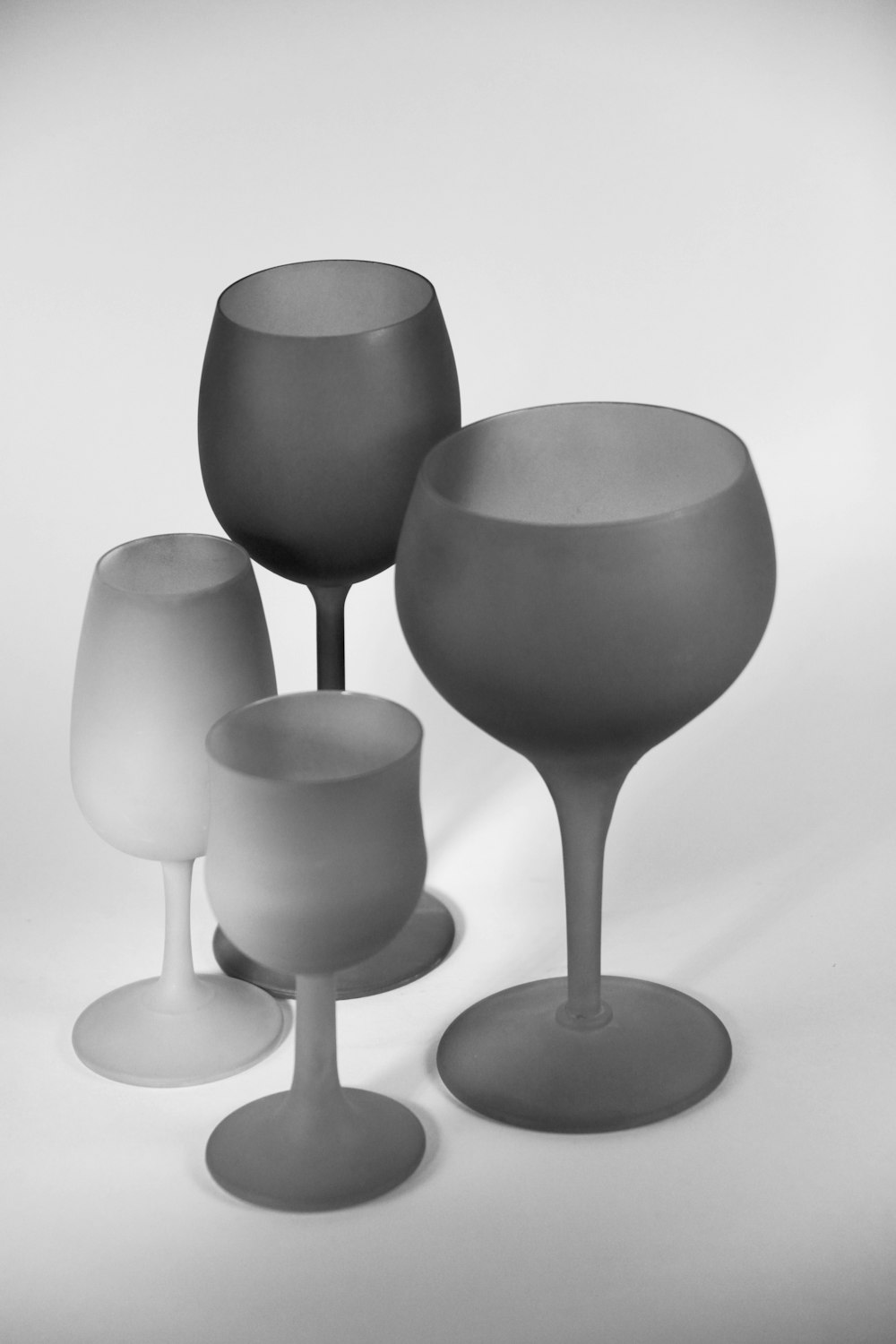four gray wine glasses illustration