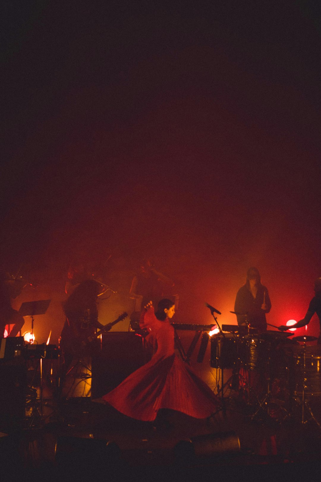 woman dancing on stage beside band group