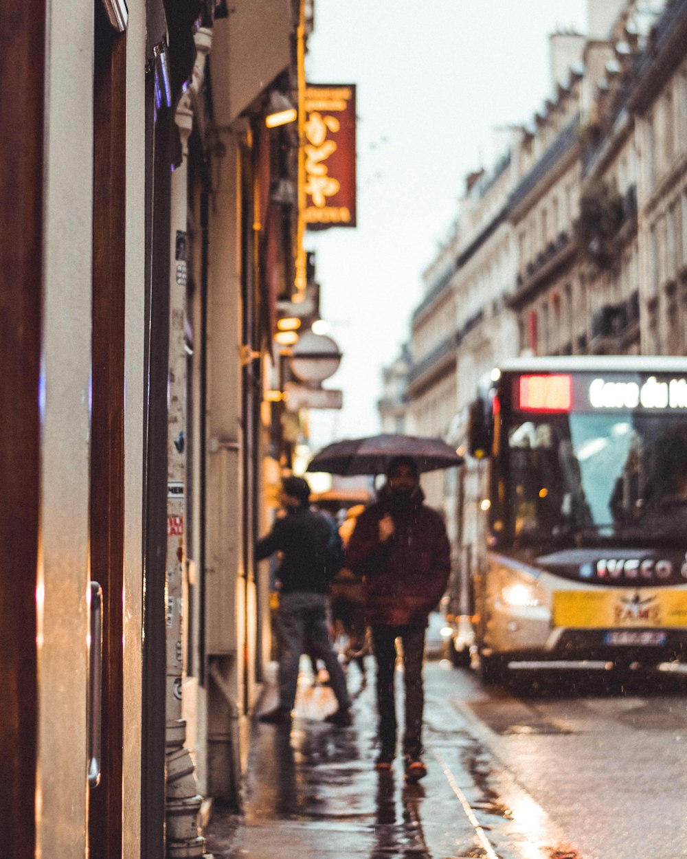 person walking holding umbrella during daytime