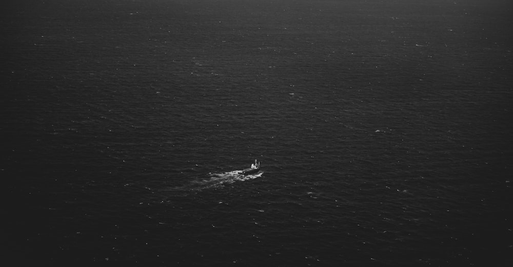 a small boat in the middle of a large body of water