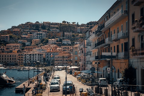 vehicles parking near building near body of water