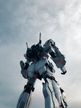 A towering nephilim giant in titan plate armor wielding massive bone saws, standing against a stark white battlefield.