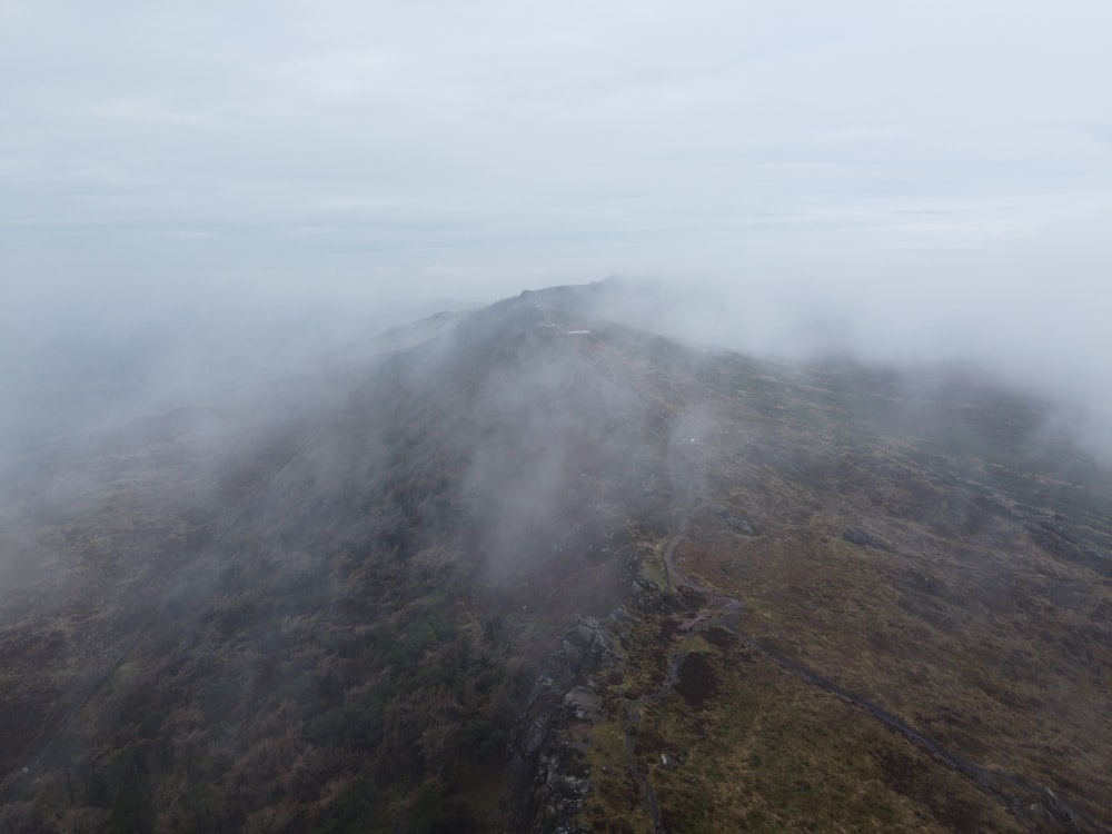 a mountain covered in fog and low lying clouds