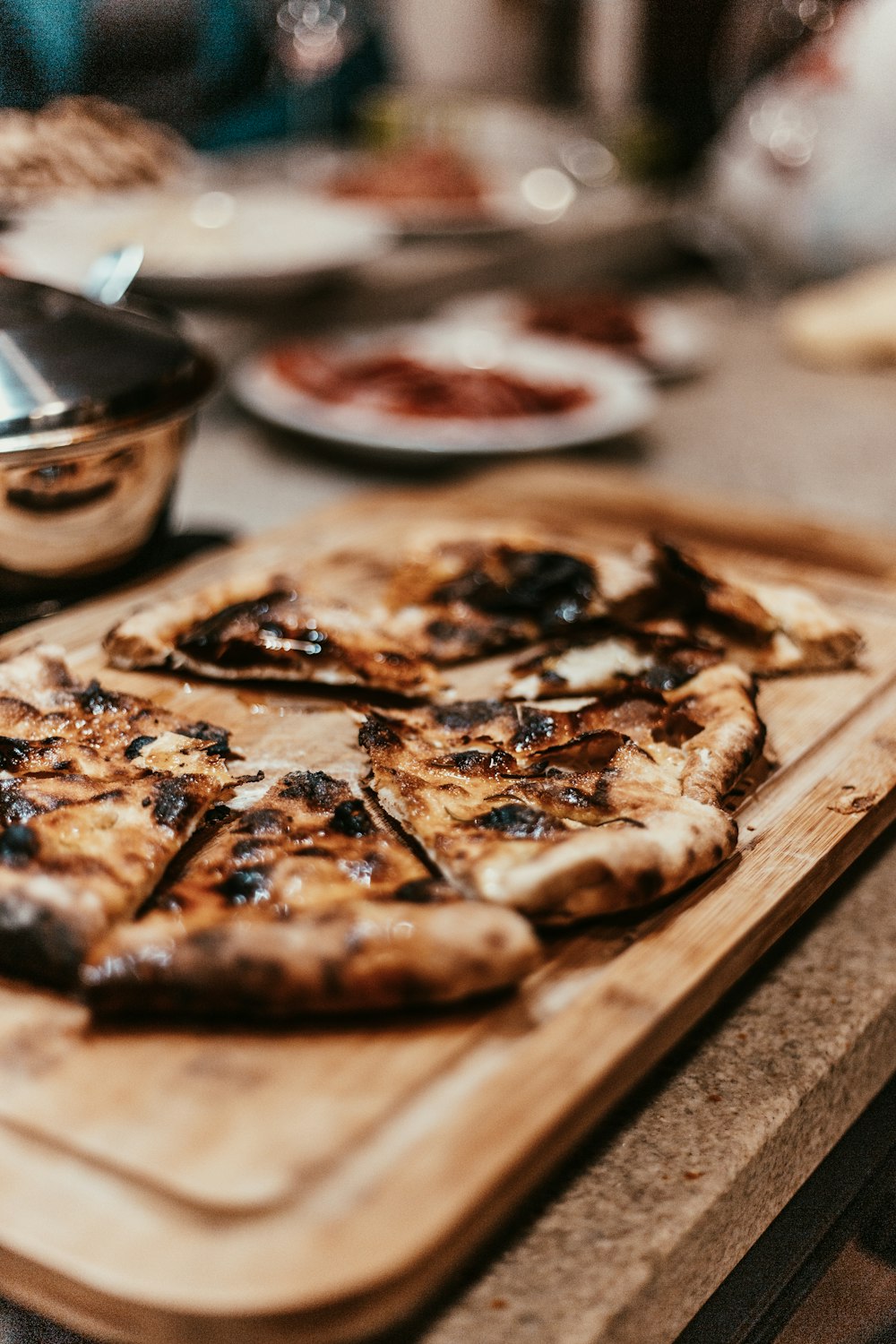 shallow focus photo of pizza on brown wooden tray