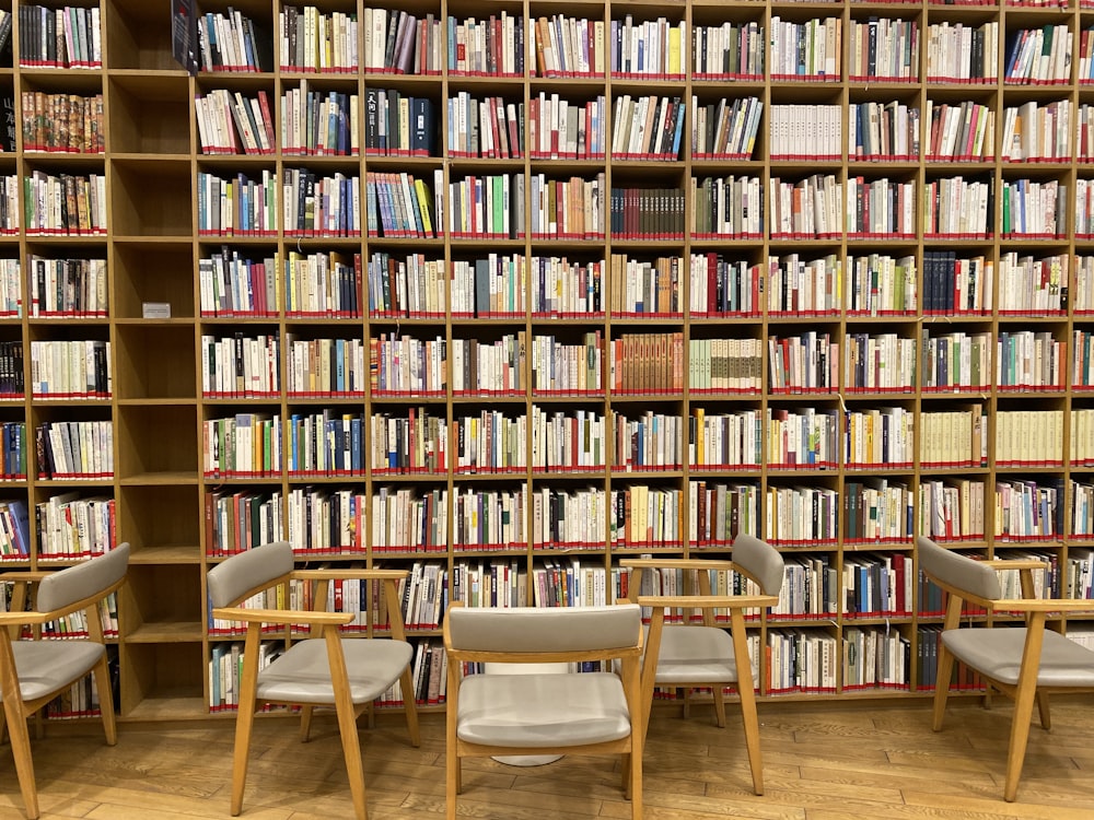 bookcase beside wooden armchairs