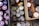 Various food items are stored in wooden crates. The assortment includes cans with green pull tabs, jars with purple lids, bottles, and boxes. The items are tightly packed, suggesting storage or organization.