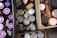 Various food items are stored in wooden crates. The assortment includes cans with green pull tabs, jars with purple lids, bottles, and boxes. The items are tightly packed, suggesting storage or organization.