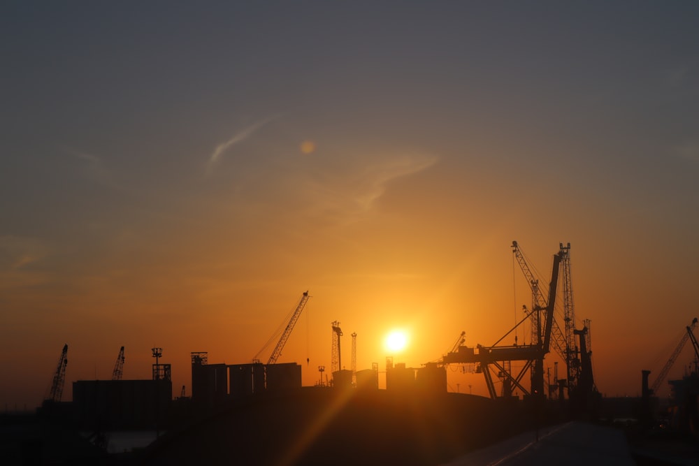 silhouette of buildings and crane