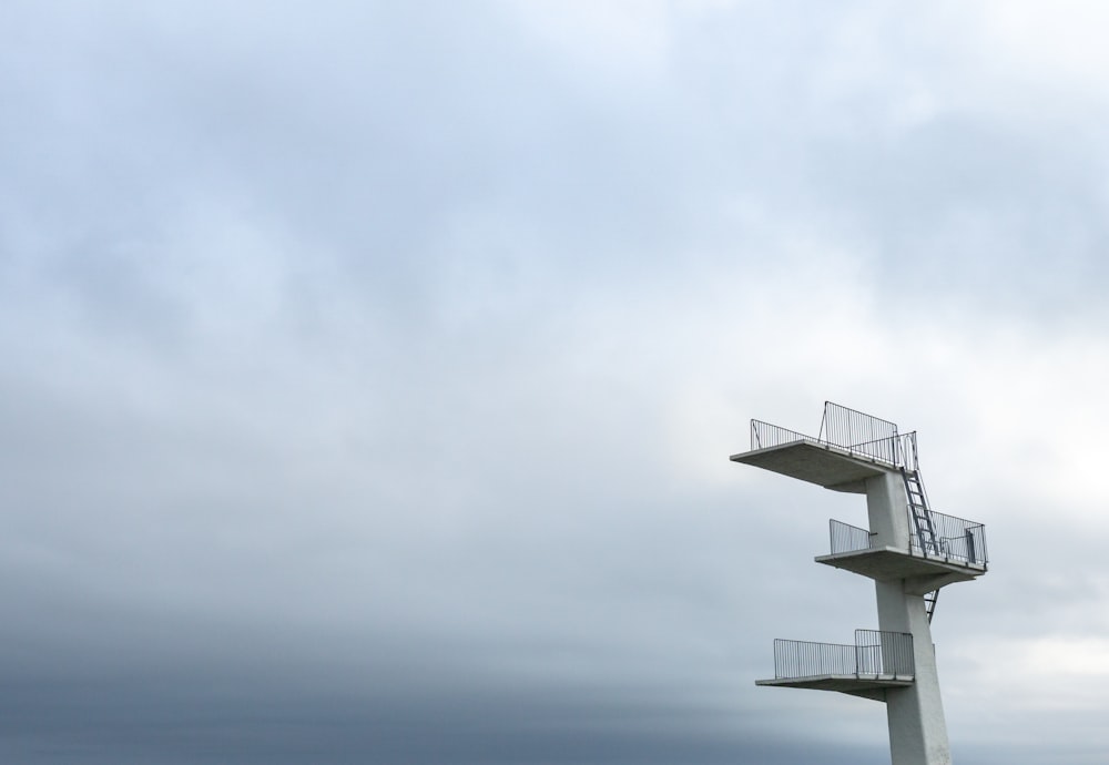 a tall white tower with a sky background