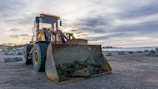 shallow focus photo of yellow front loader