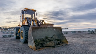 shallow focus photo of yellow front loader