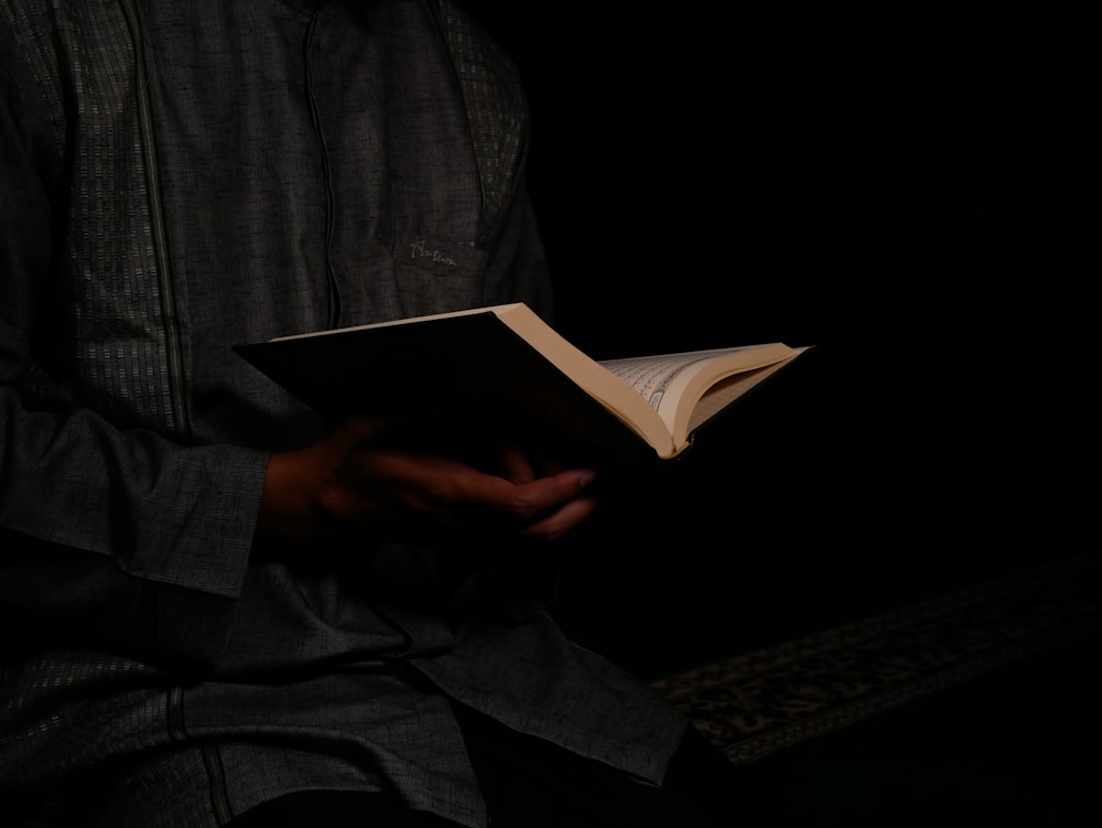 person holding opened book