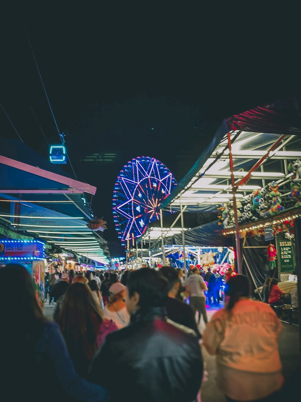 people walking in amusement park at night