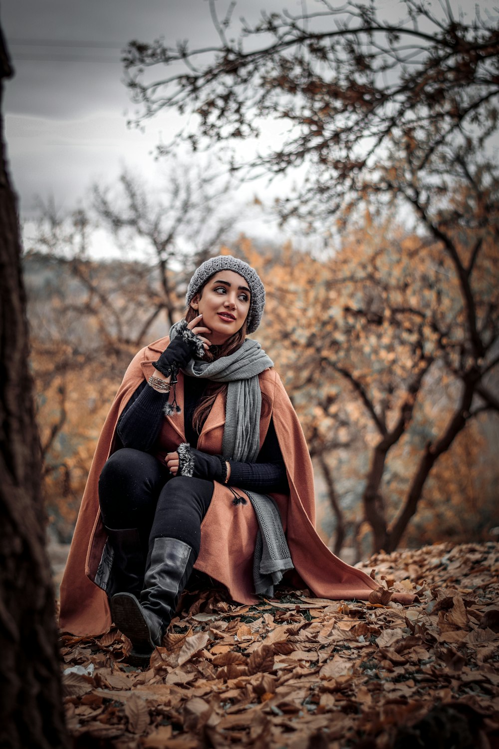 woman sitting near trees during day