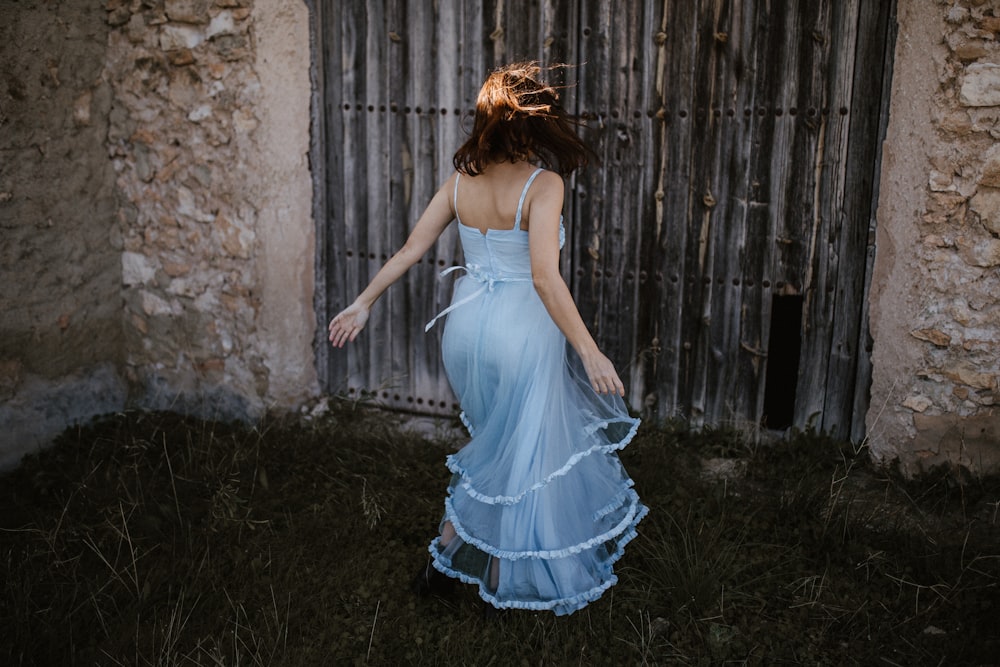 woman wearing blue spaghetti strap dress
