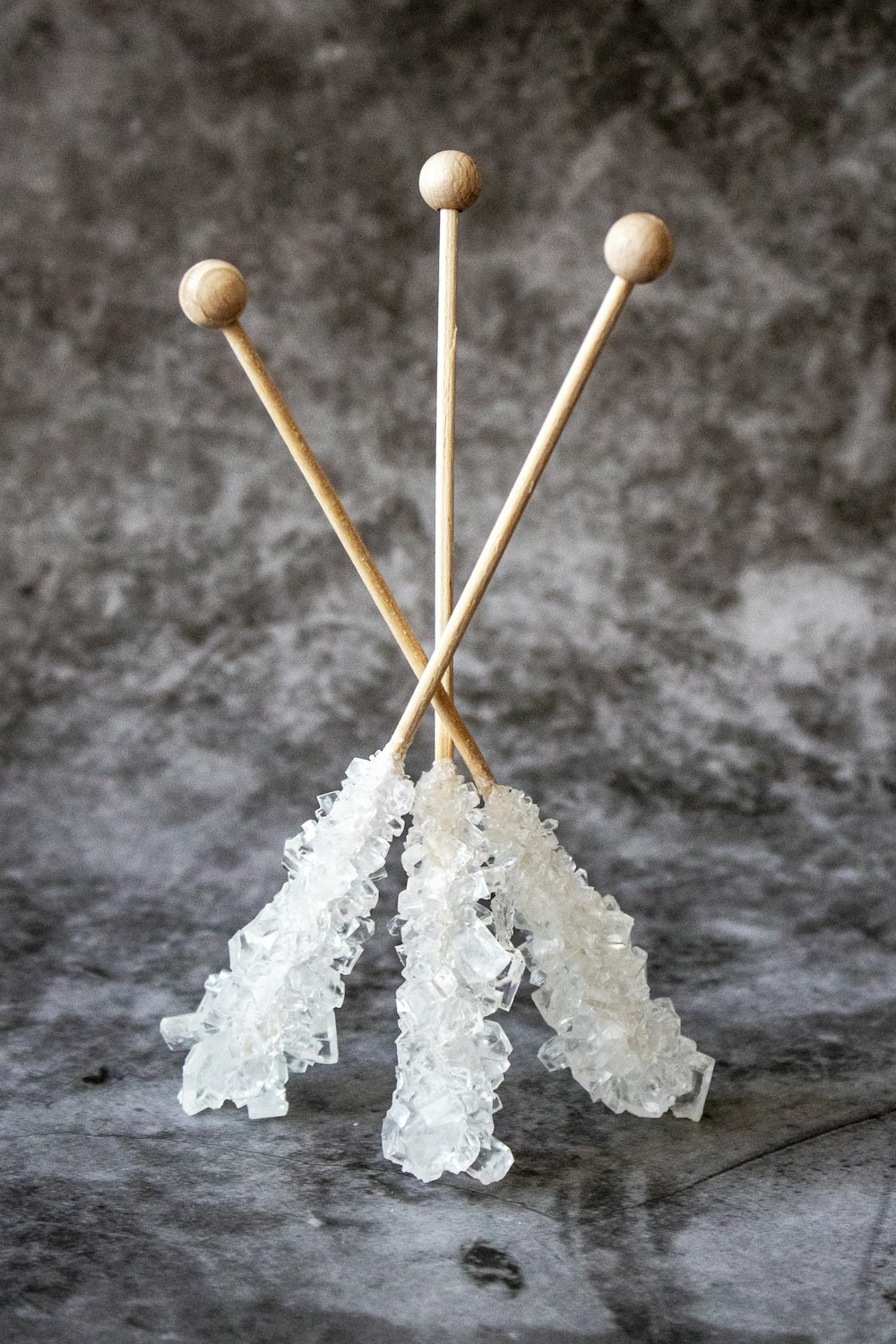 three brown wooden sticks with quartz