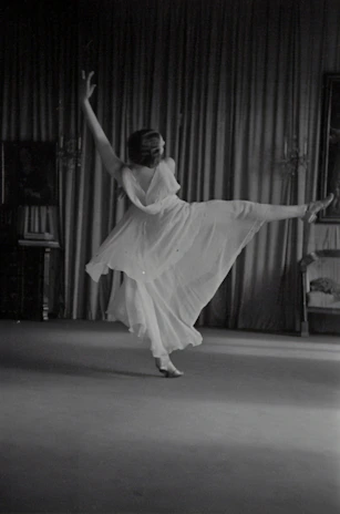 Instructor demonstrating a smooth salsa step with elegant posture and focus.