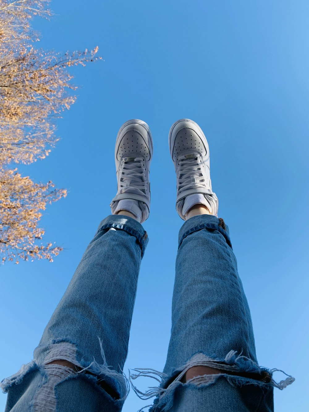 person wearing white sneakers