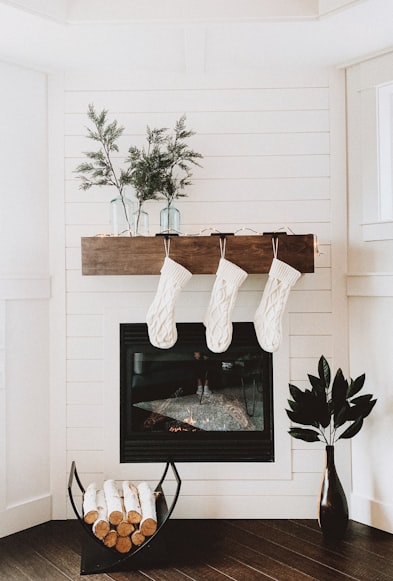 firewood on rack near fireplace - photo by Genevieve Rusnac on unsplash.com