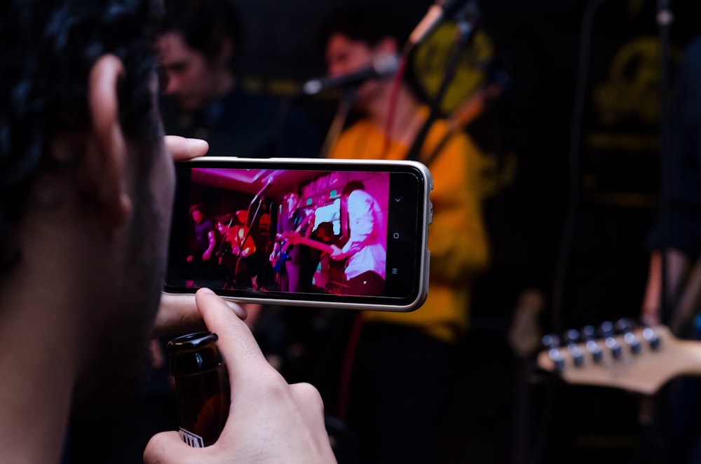 peeson holding black phone