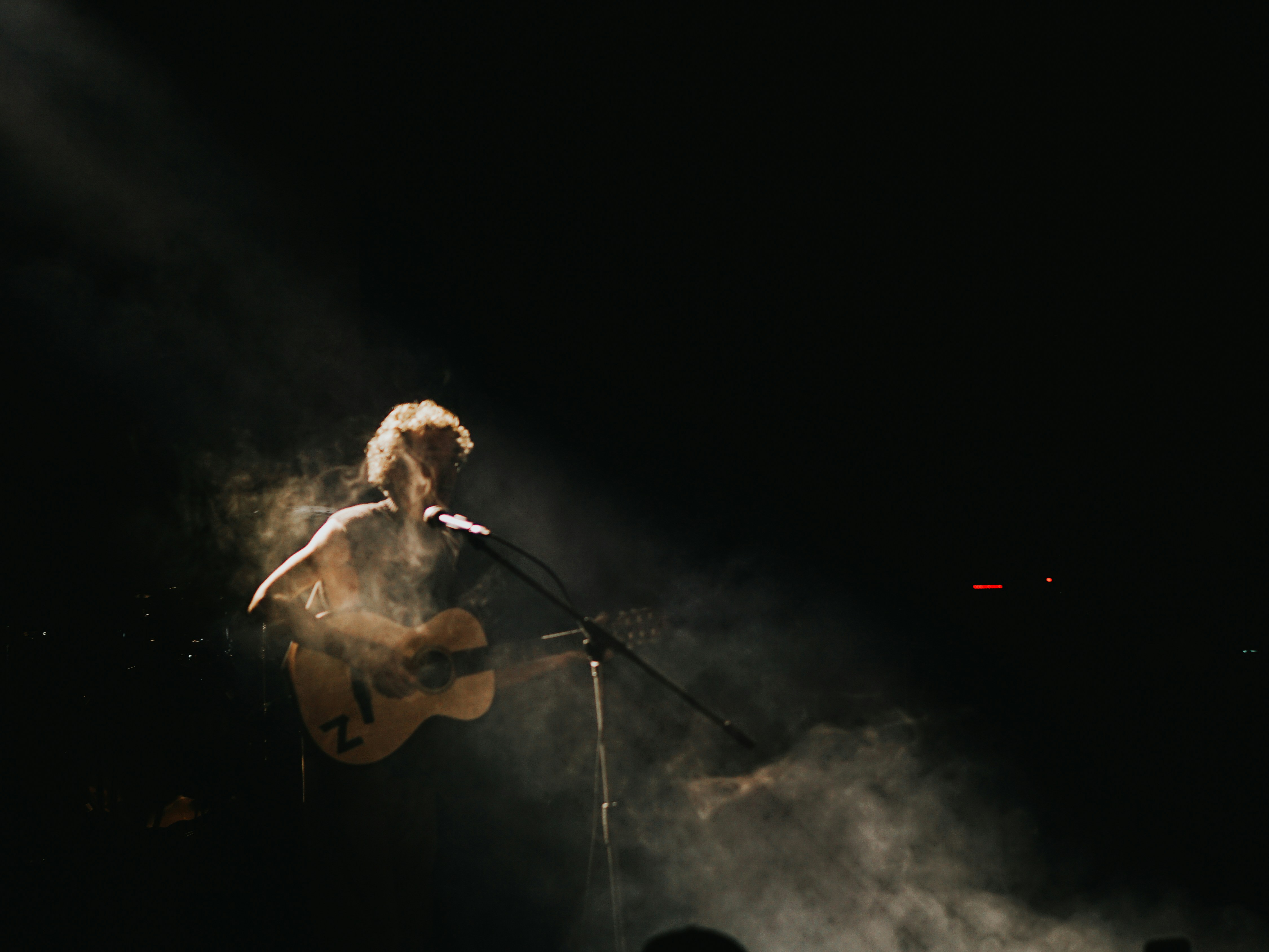 Drake Bell performing on stage with a guitar - drake bell