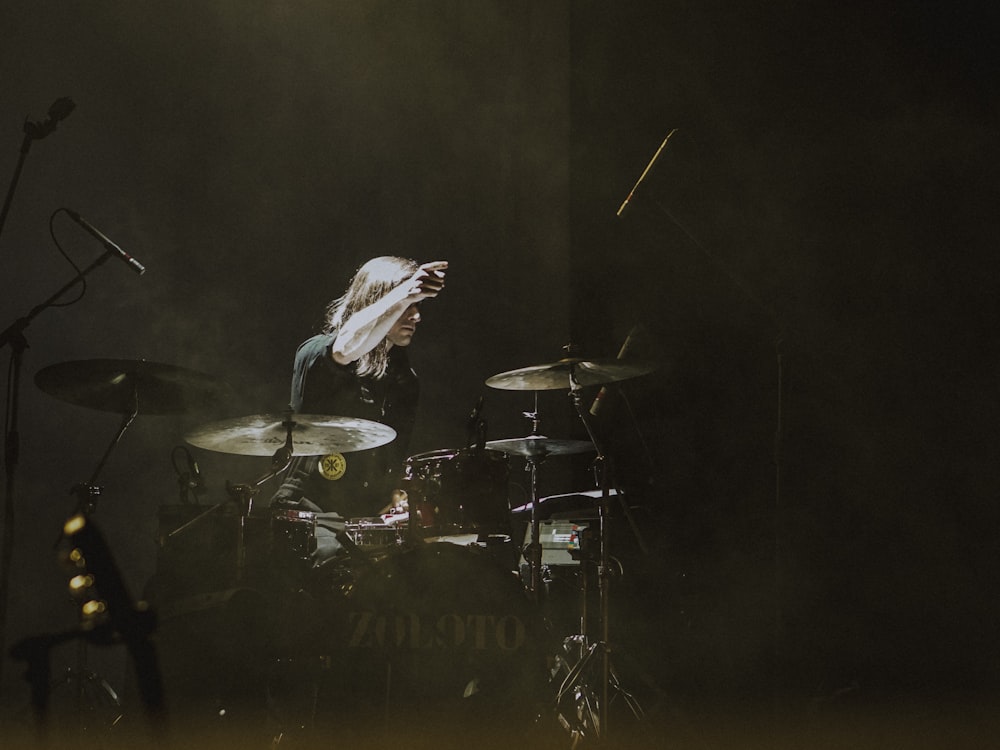 person playing drum set