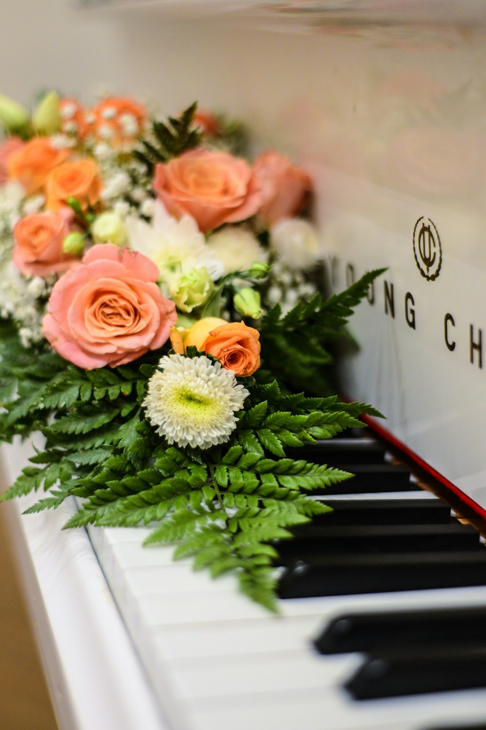 multicolored flowers on piano keys