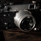 A close-up photograph of a vintage film camera with textured details.