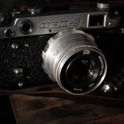 A close-up photograph of a vintage film camera with textured details.