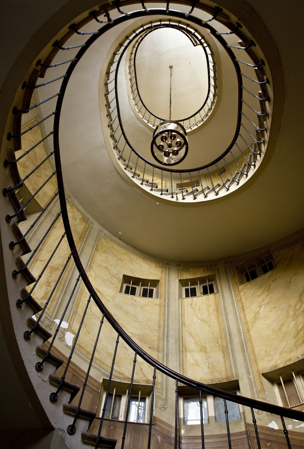 spiral stairs with chandelier