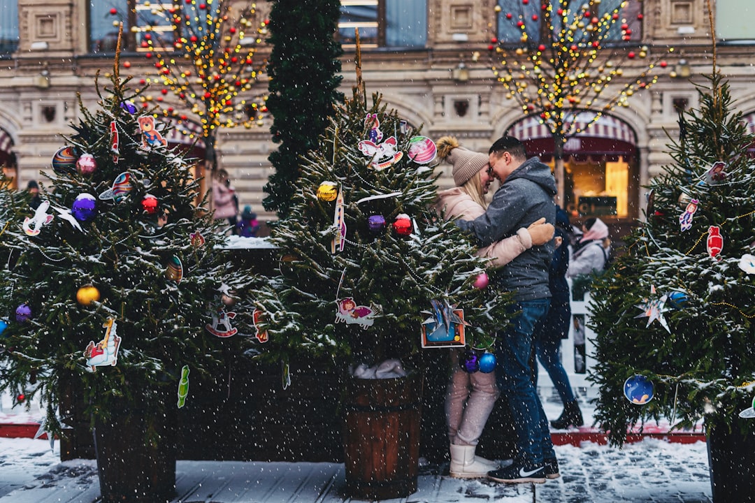 couple near Christmas trees on street