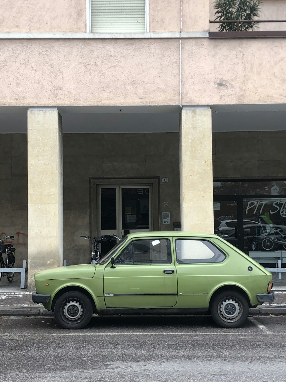 green vehicle near white house