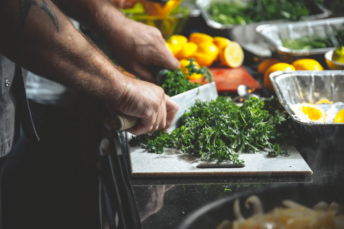 Fresh herbs being sliced on a cutting board