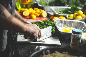 person slicing herbs