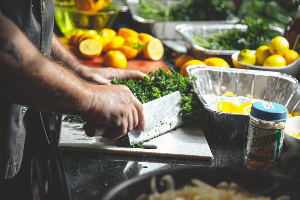 person slicing herbs