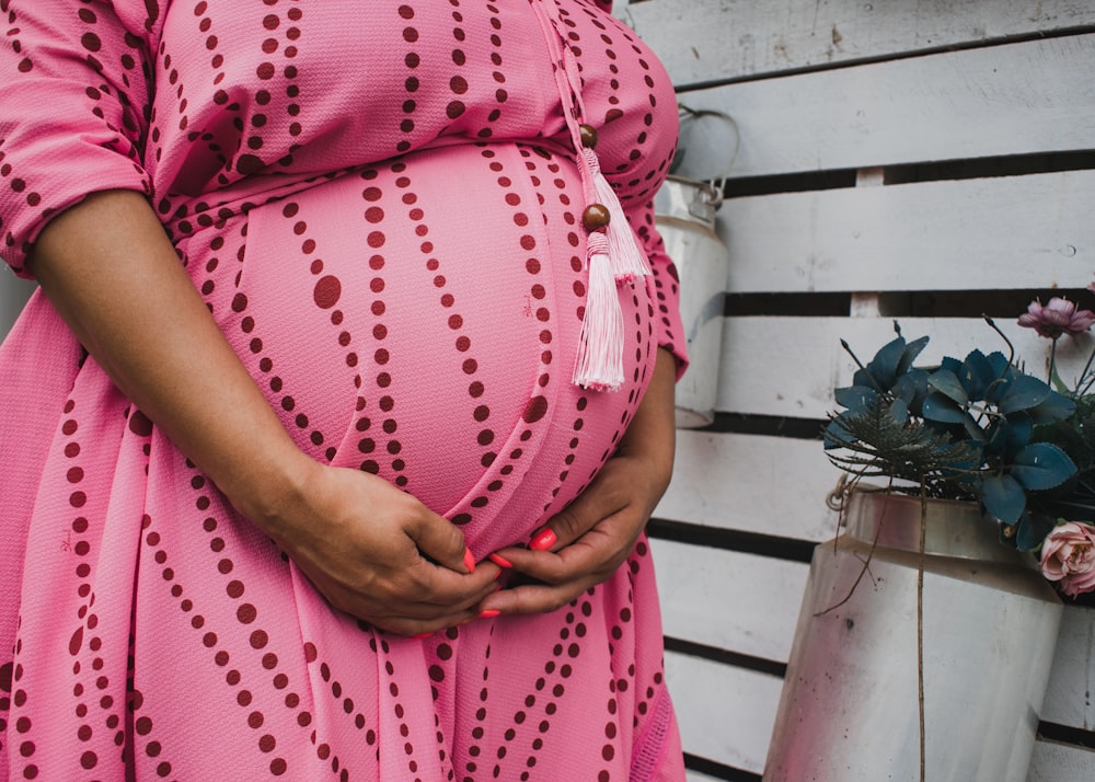 women's pink and red long-sleeved maternity dress