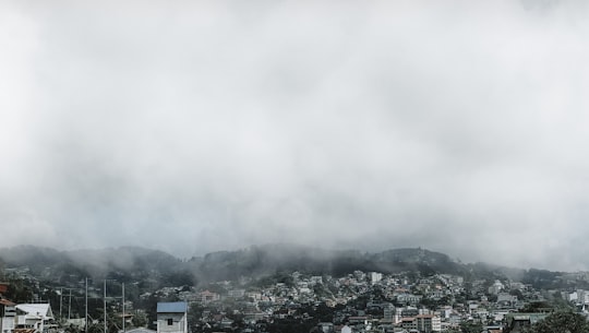 aerial photography of houses and buildings viewing mountain in foggy day in Baguio Philippines