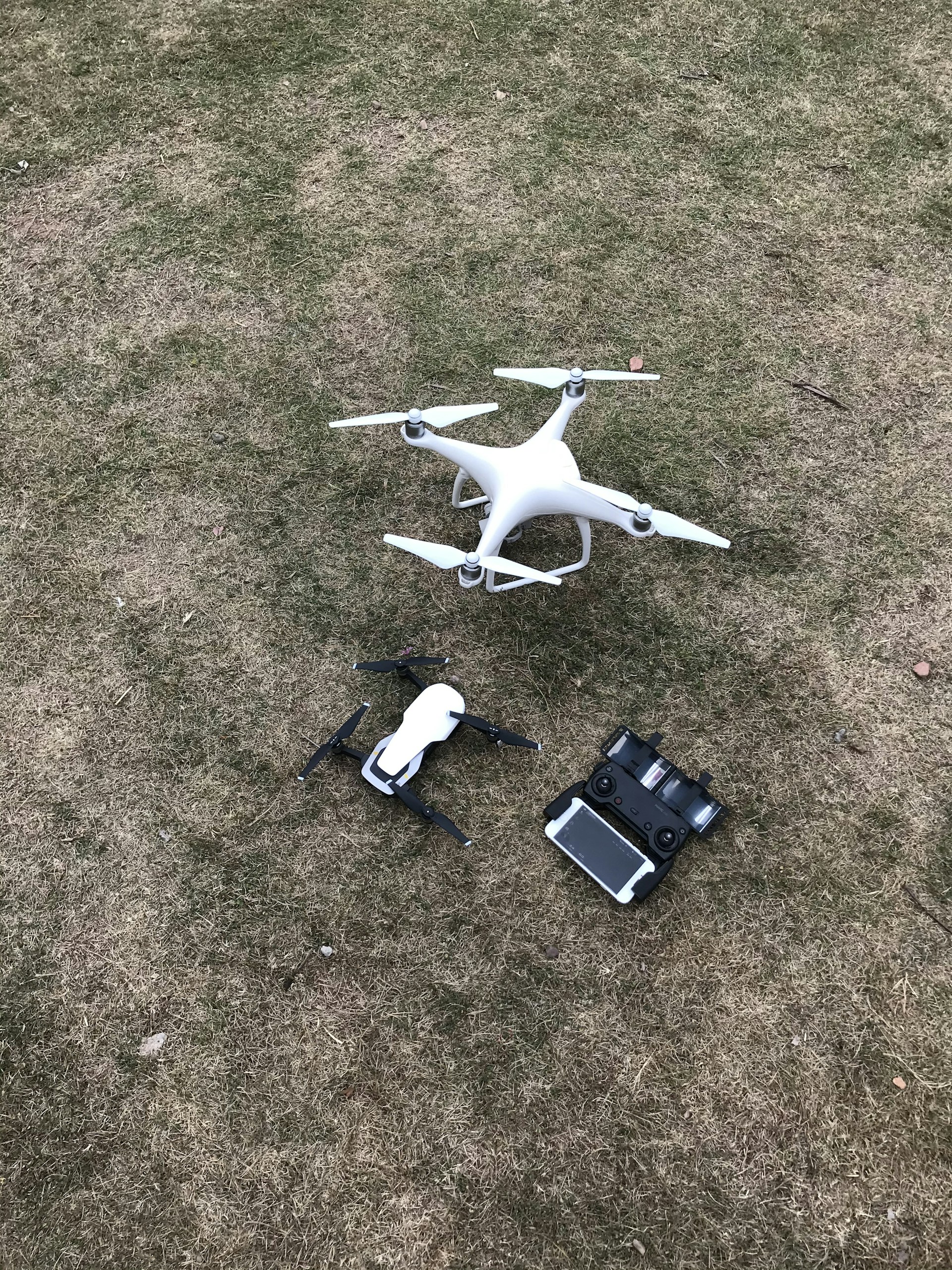 white DJI Mavic Pro drone set on grass