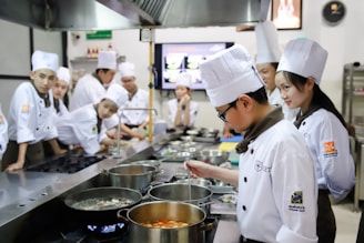 chefs standing near cooking pots inside kitchen