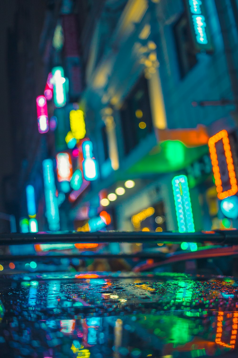 a city street filled with lots of neon lights
