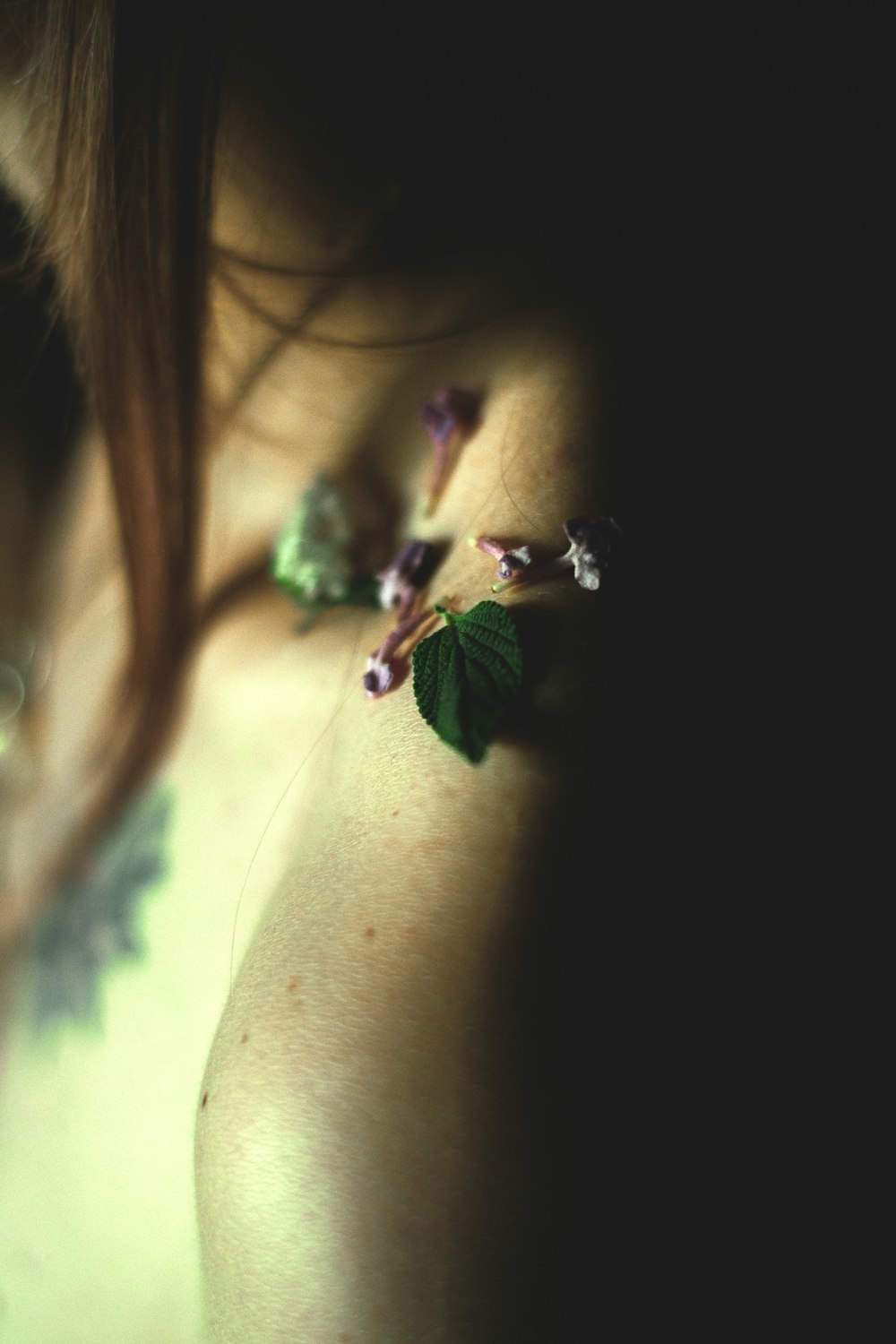 a close up of a woman's breast with a flower on it