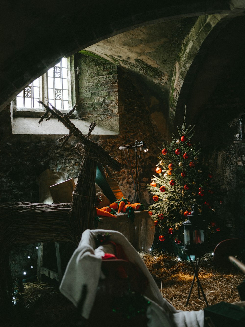 Christmas tree near window near white textile