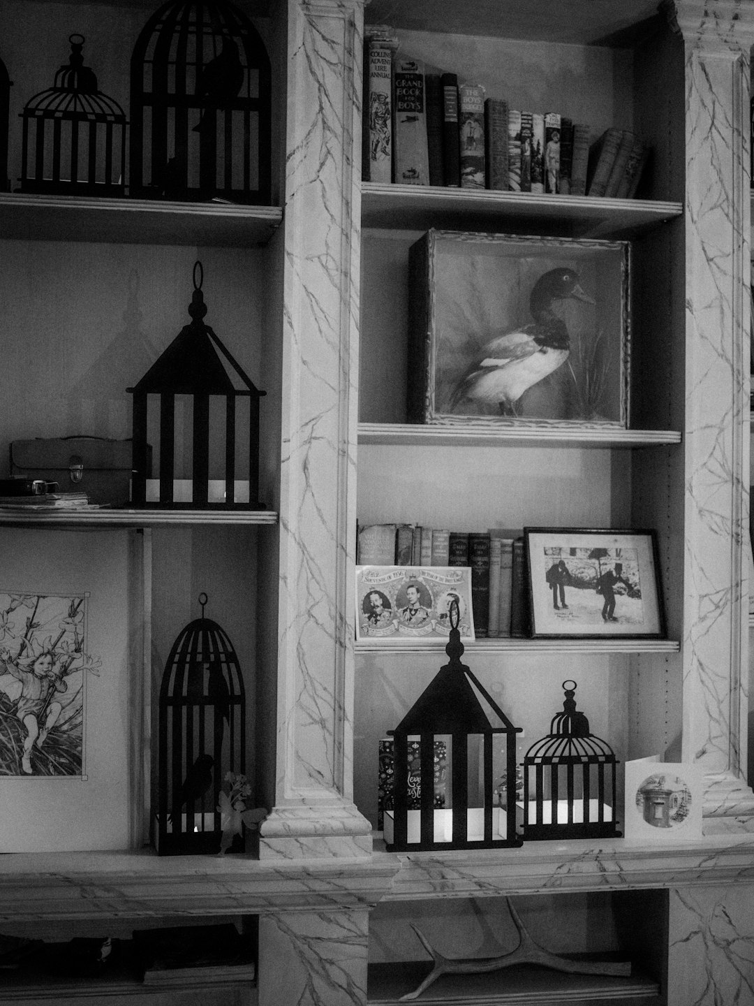 grayscale photo of lanterns in shelf