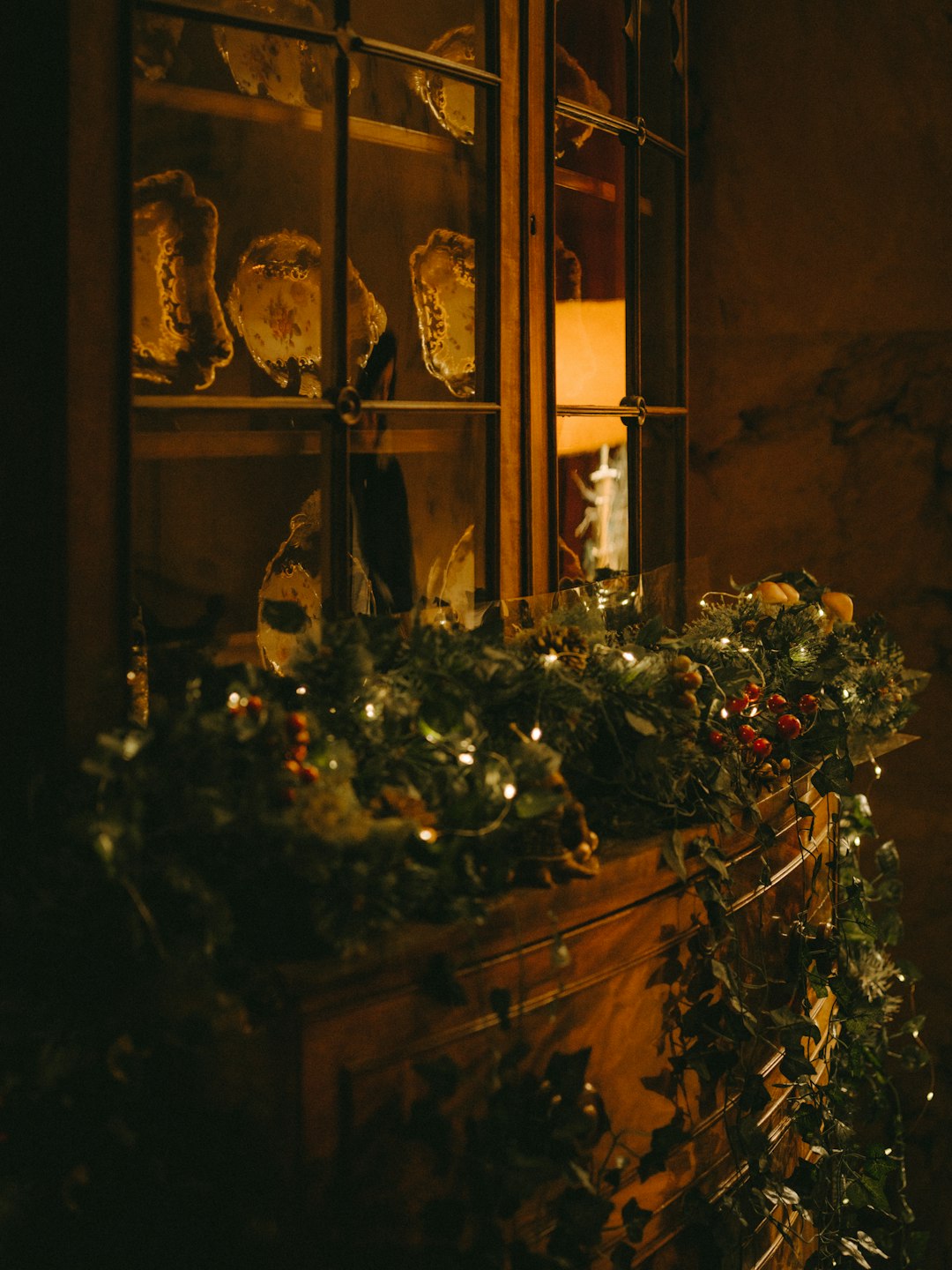 display cabinet with decorative dishes and plants