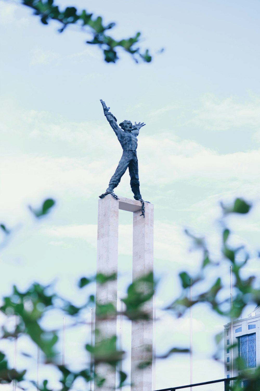 human statue on tower during day