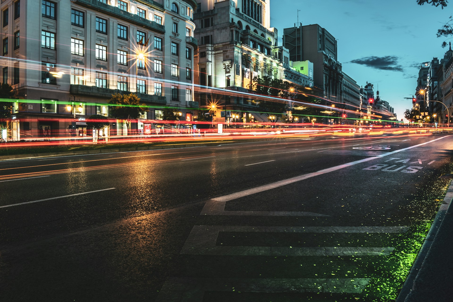 An urban scene at dusk with soft glowing streetlights and dynamic architectural lines.