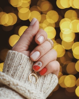 gold-colored hoop earring on human hand
