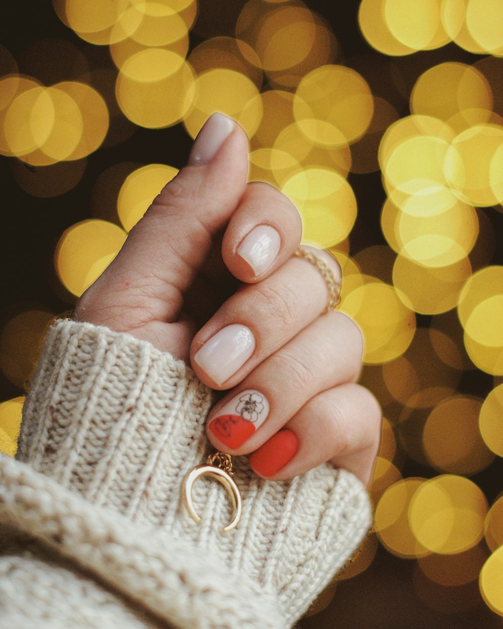 gold-colored hoop earring on human hand