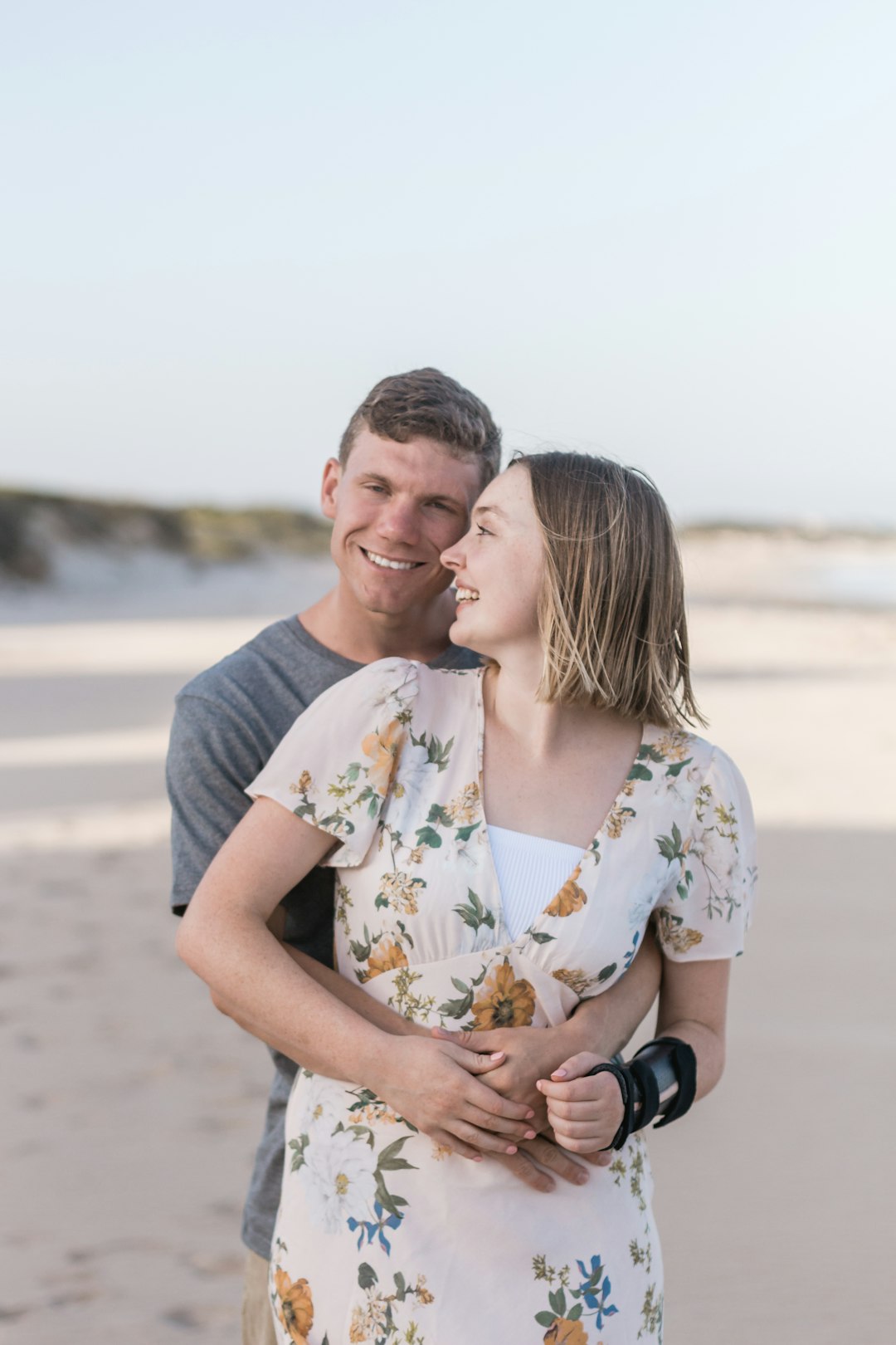 man hugging a woman on her back